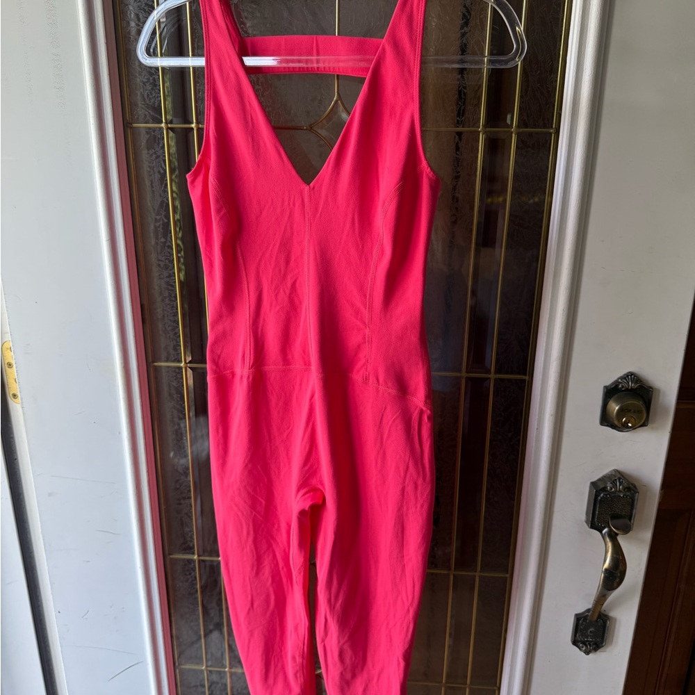 FREE PEOPLE NEVER BETTER ONE  Piece, in coral. NWOT …. Perfect for a nice run!
